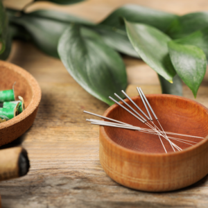 acupuncture needles in a cup